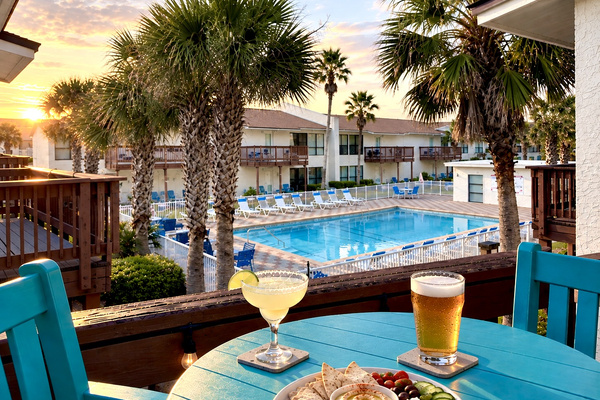 Your "Poolside Paradise" at stunning Navarre Beach. The palm-lined pool deck is just steps from your door, with loungers, patio seating, and a private grilling areas. The perfect spot to unwind between visits to Florida's most relaxing beach!