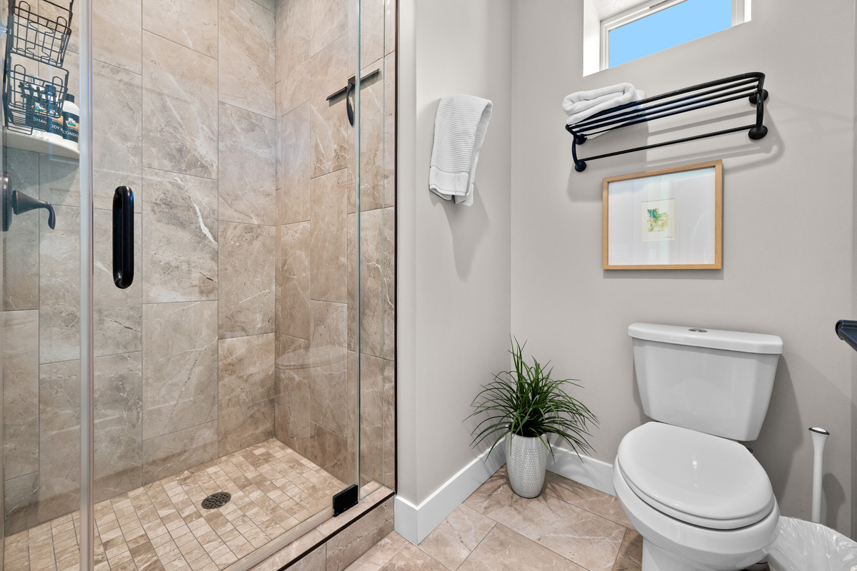 Beautiful full bathroom with a walk-in glass shower, modern fixtures, and fresh, upscale finishes.