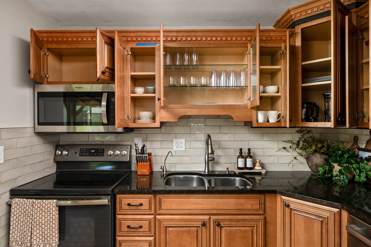 Fully stocked kitchen with cookware, dishes, utensils, and essentials to make preparing meals during your stay simple and convenient.