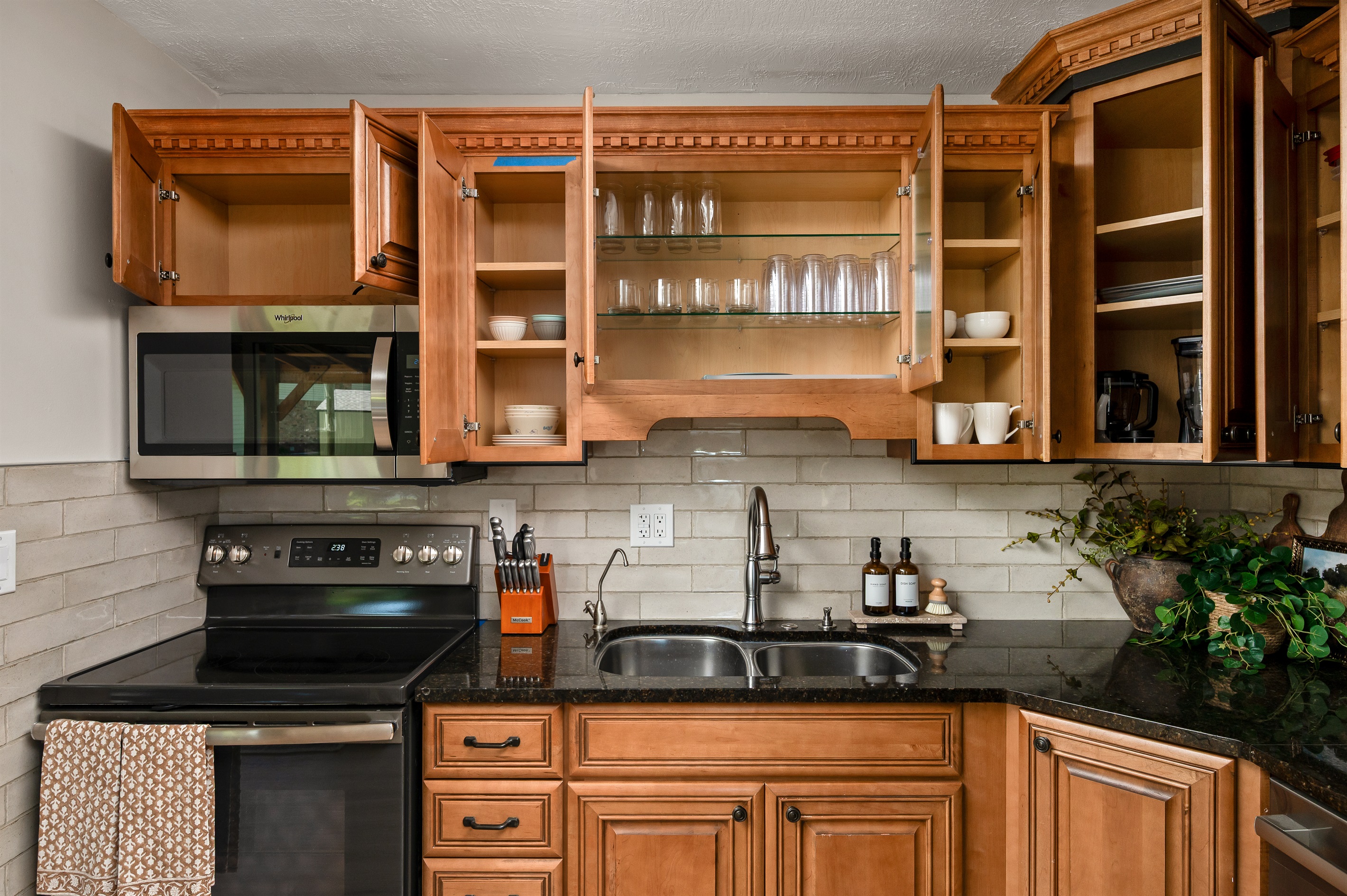 Fully stocked kitchen with cookware, dishes, utensils, and essentials to make preparing meals during your stay simple and convenient.