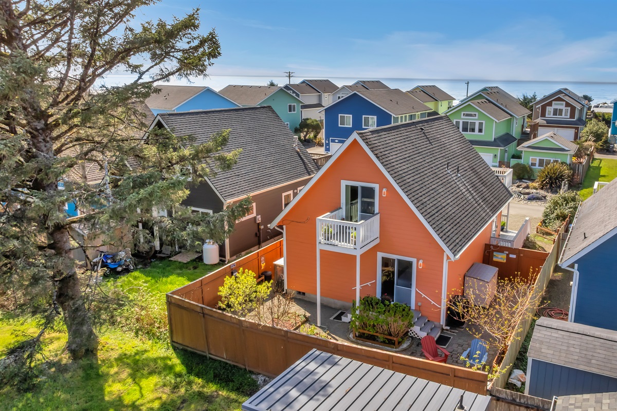Sunkissed's backyard sports an infrared grill, propane fire pit, Adirondack chairs, and edible gardens.
