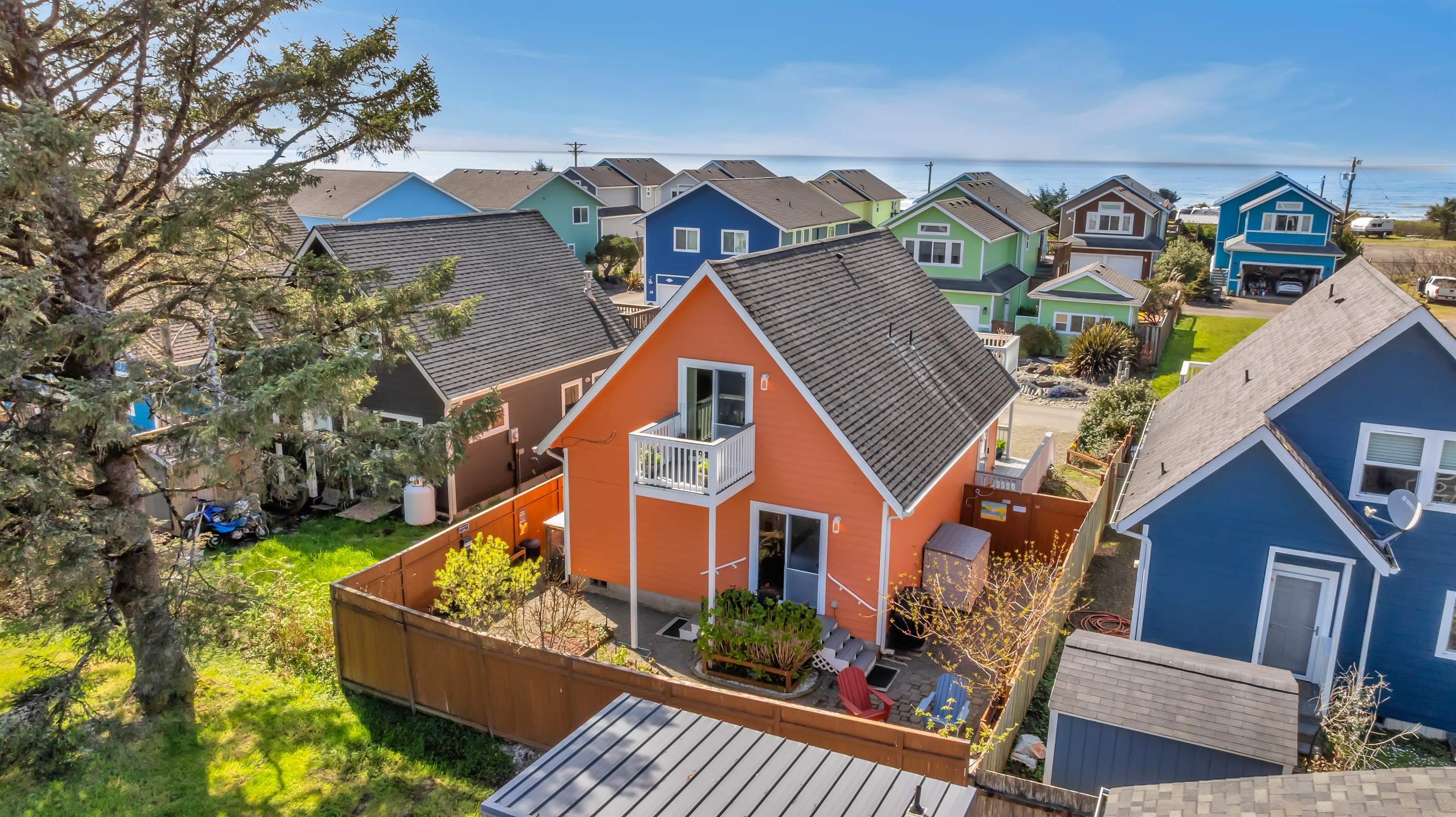 Sunkissed's backyard sports an infrared grill, propane fire pit, Adirondack chairs, and edible gardens.