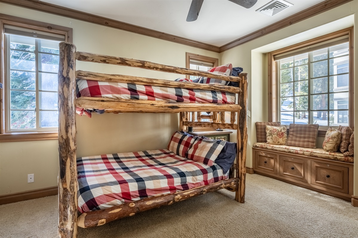 The Charming Chalet's bunkroom includes full over full bunks in a light-filled, South facing room with built in window seat. The log beds are built for children or adults.