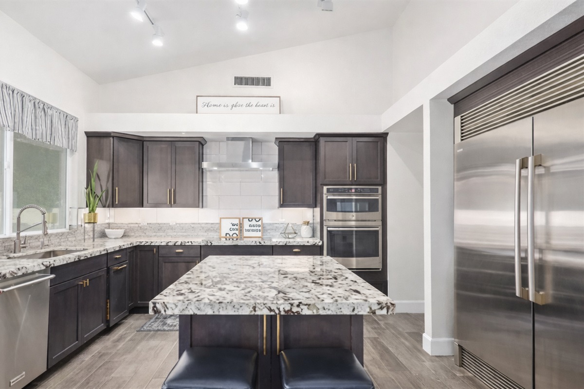 This chef-inspired kitchen offers high-end finishes, double ovens, and a huge island perfect for family meals and entertaining.