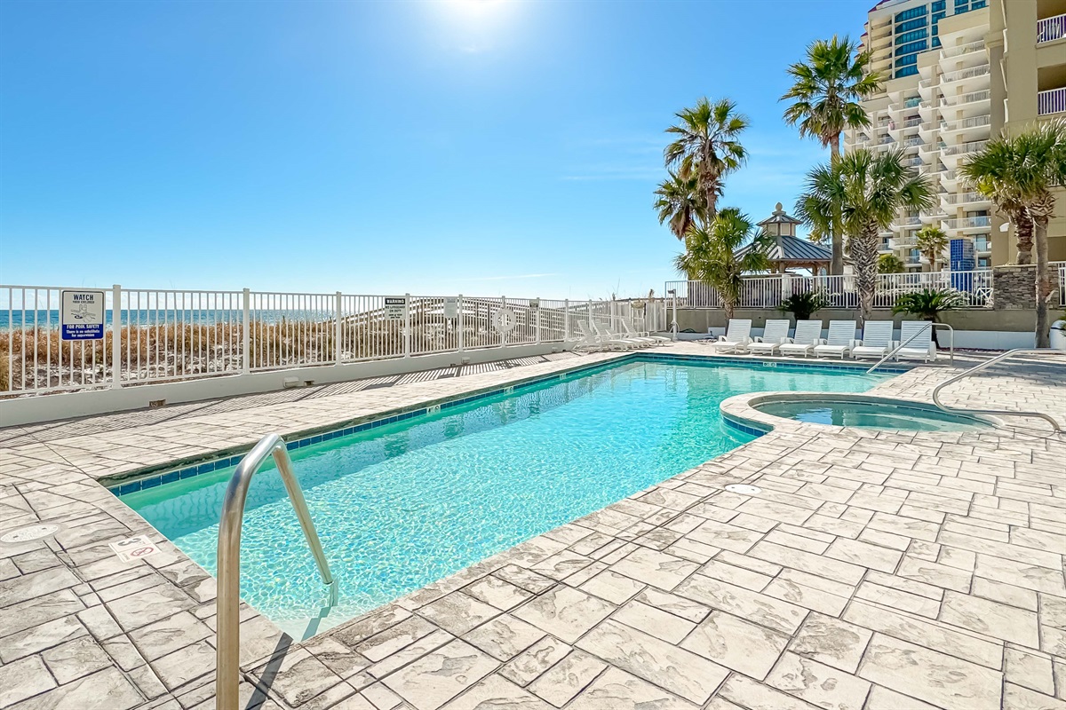 Where the pool meets the ocean.  Enjoy a seamless blend of relaxation and recreation in this idyllic beachfront setting.