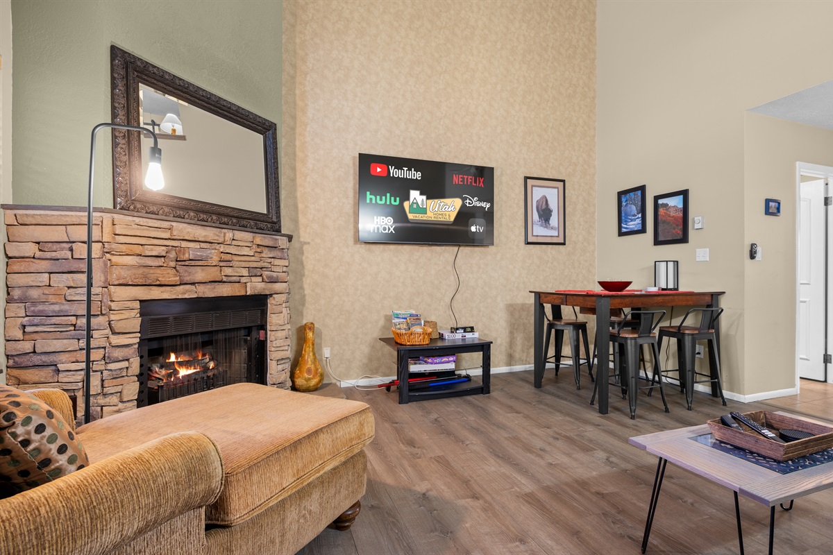 Open-concept living and dining area with comfortable seating, fireplace, and plenty of space to gather.