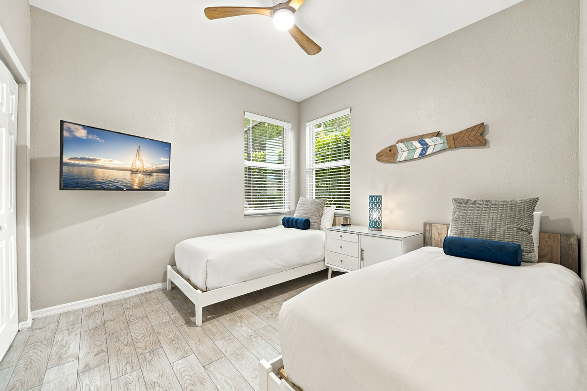 Twin bedroom features a TV, ideal for late nights