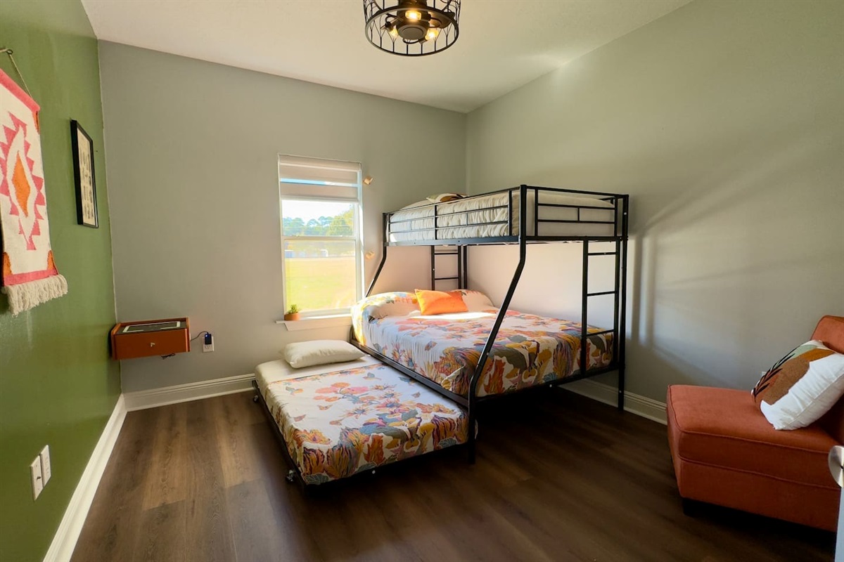 Twin top bunk, full middle bed, and pull-out trundle maximize sleeping capacity without sacrificing comfort