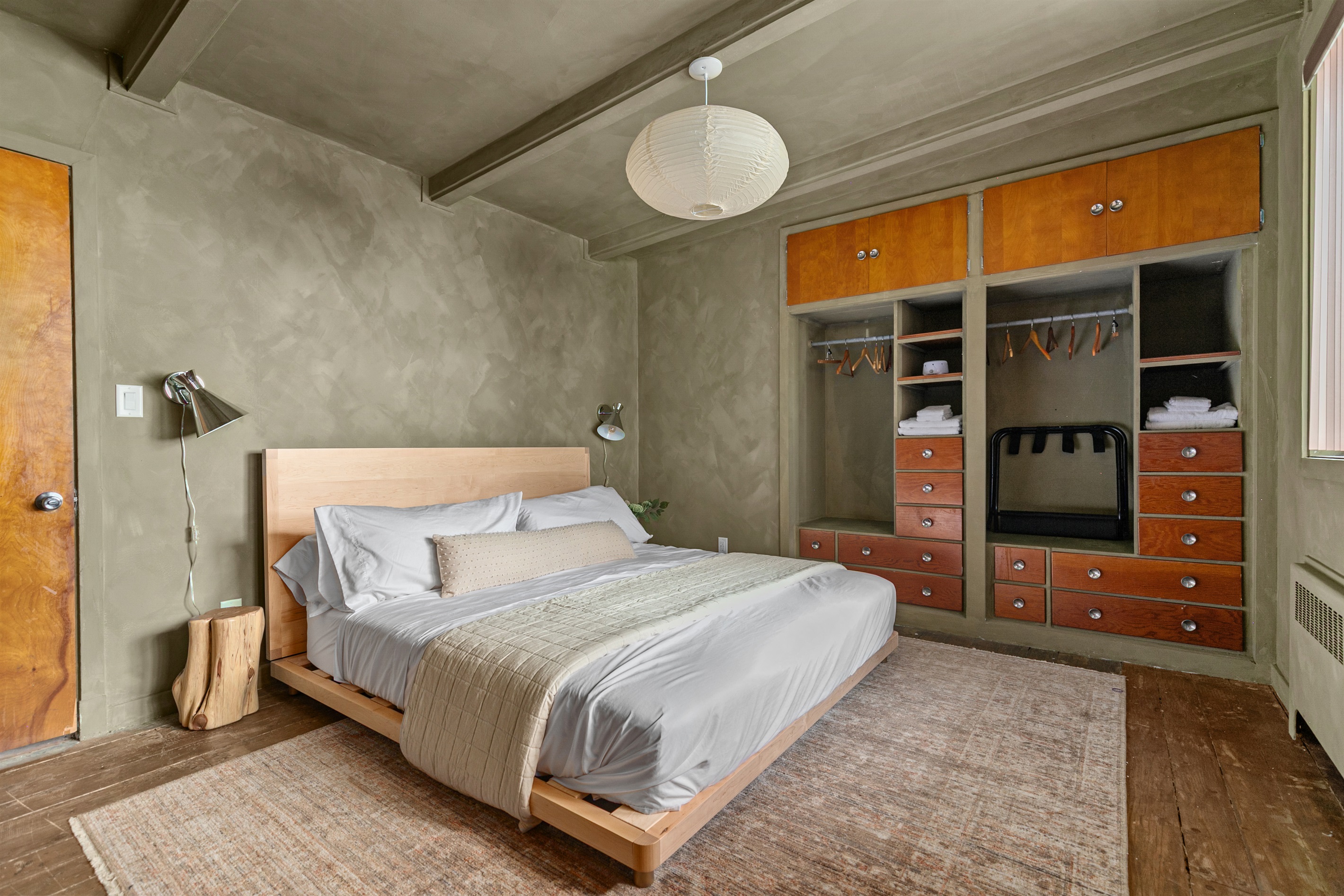 The queen-size bedroom is styled for comfort and ease, complete with bedside tables and a lamp that make winding down at night or starting the morning simple.