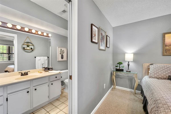 Bath Retreat: Stylish space with sleek fixtures and bright lighting, perfect for a refreshing start!