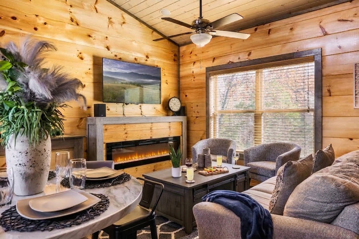 Escape to your private mountain retreat, where warm wood tones and the soft glow of the fireplace set the scene for unforgettable evenings together. Unwind with a glass of wine, sink into ultimate comfort, and let the quiet charm of the cabin do the rest. 