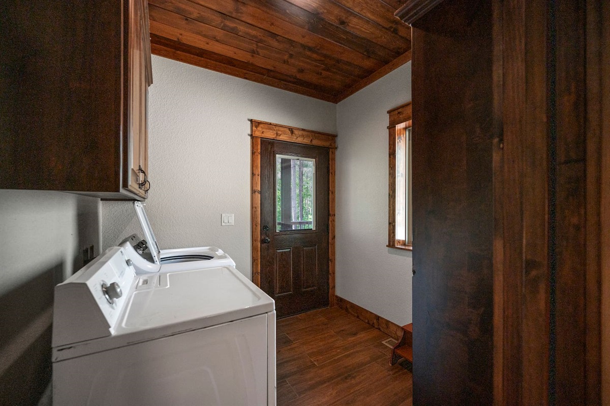 Laundry room contains full size washer and dryer as well as sink for rinsing things out