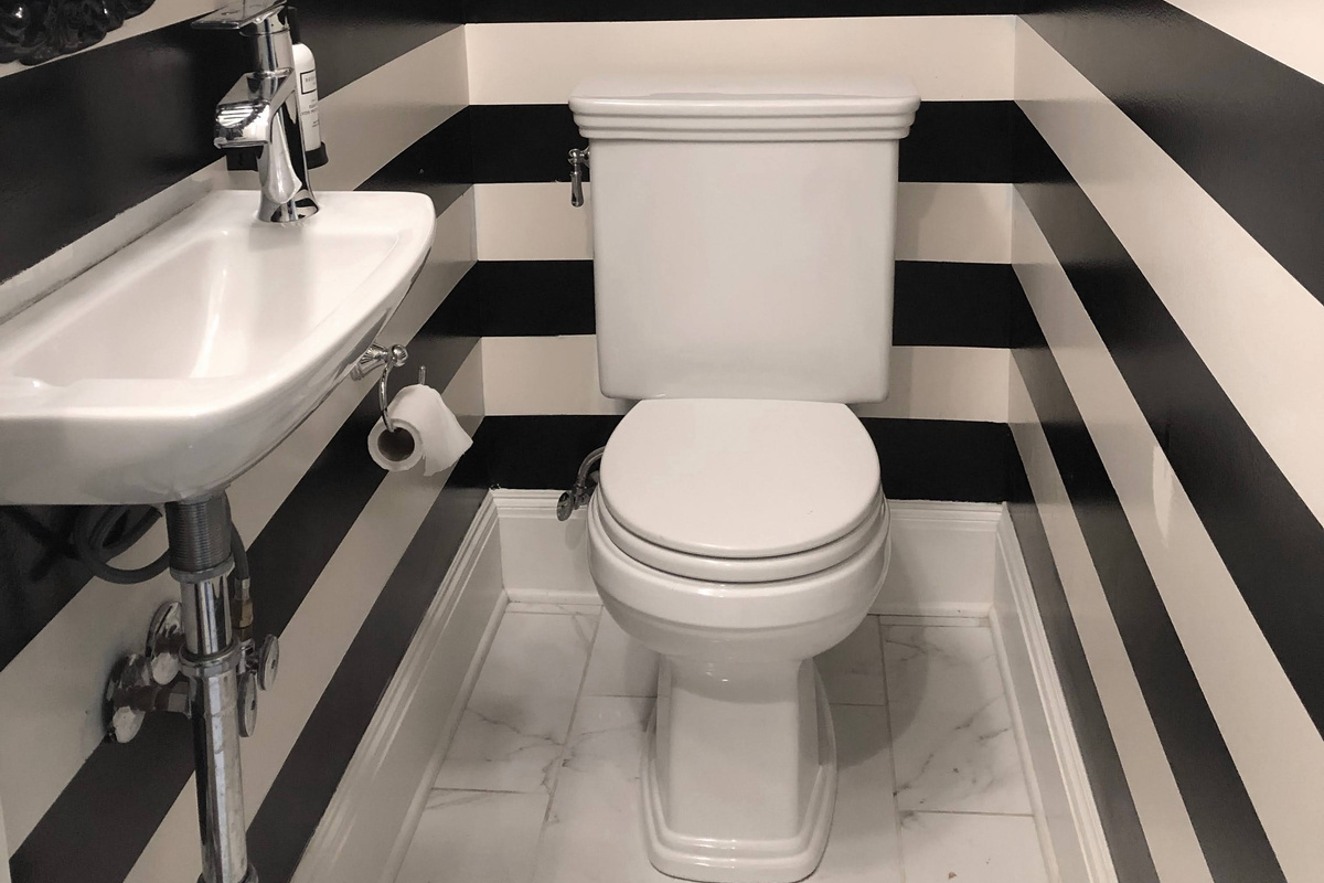Stylish first-floor half bath just off the living and dining areas—perfect for quick access and guest convenience.