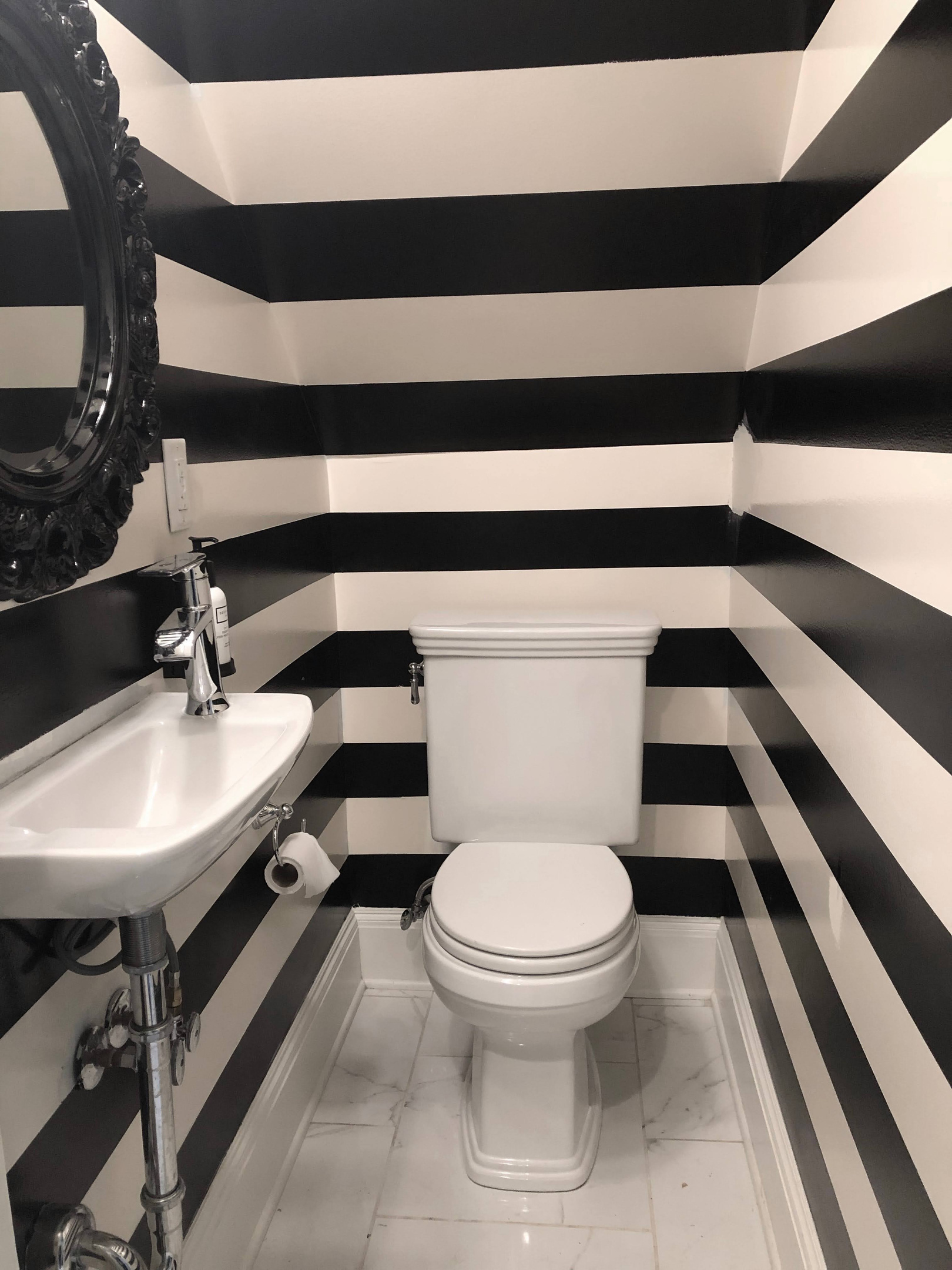 Stylish first-floor half bath just off the living and dining areas—perfect for quick access and guest convenience.