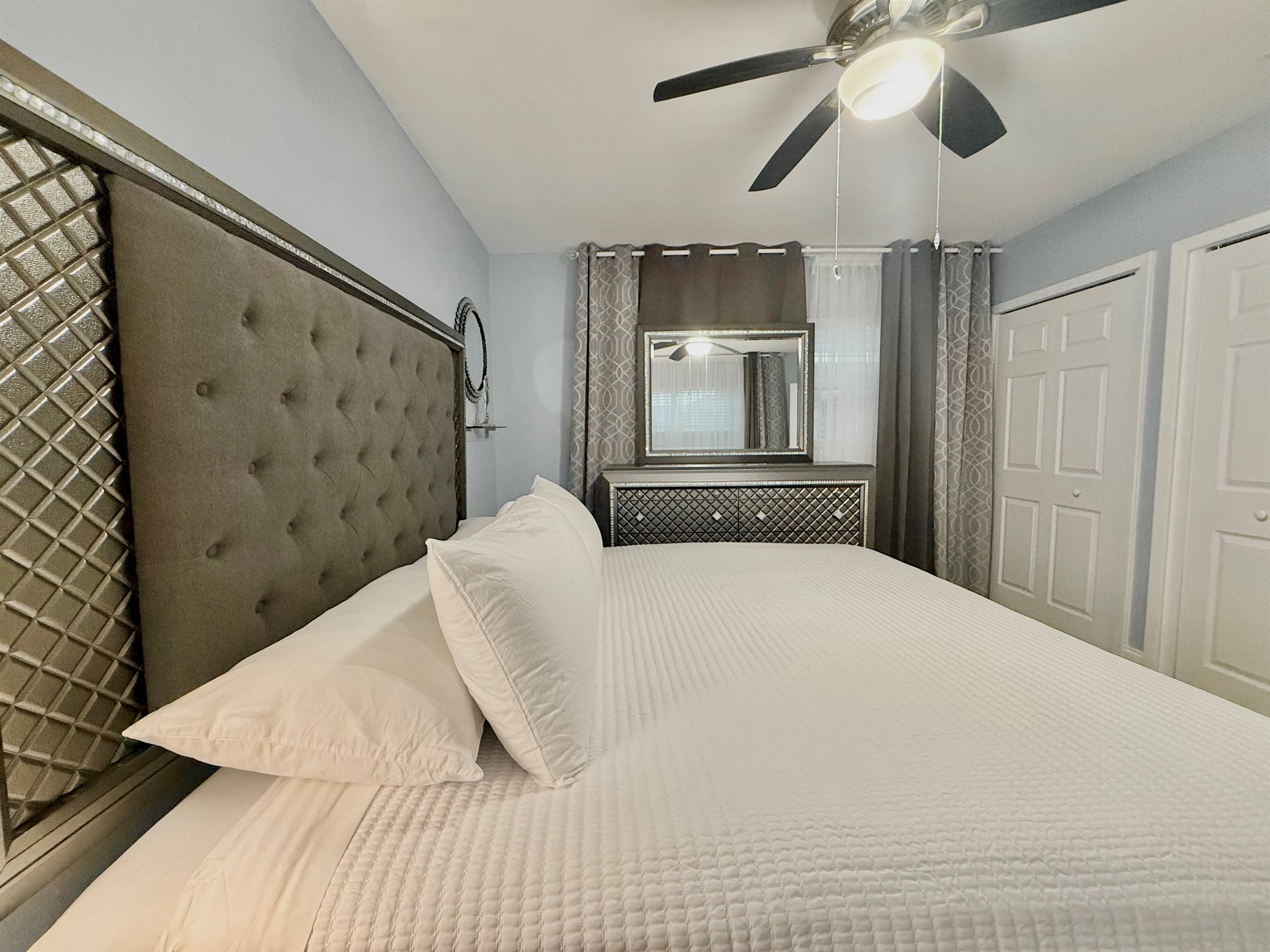 Sleep like royalty in this beautifully appointed room with a luxurious king bed, plush linens, and chic mirrored accents.