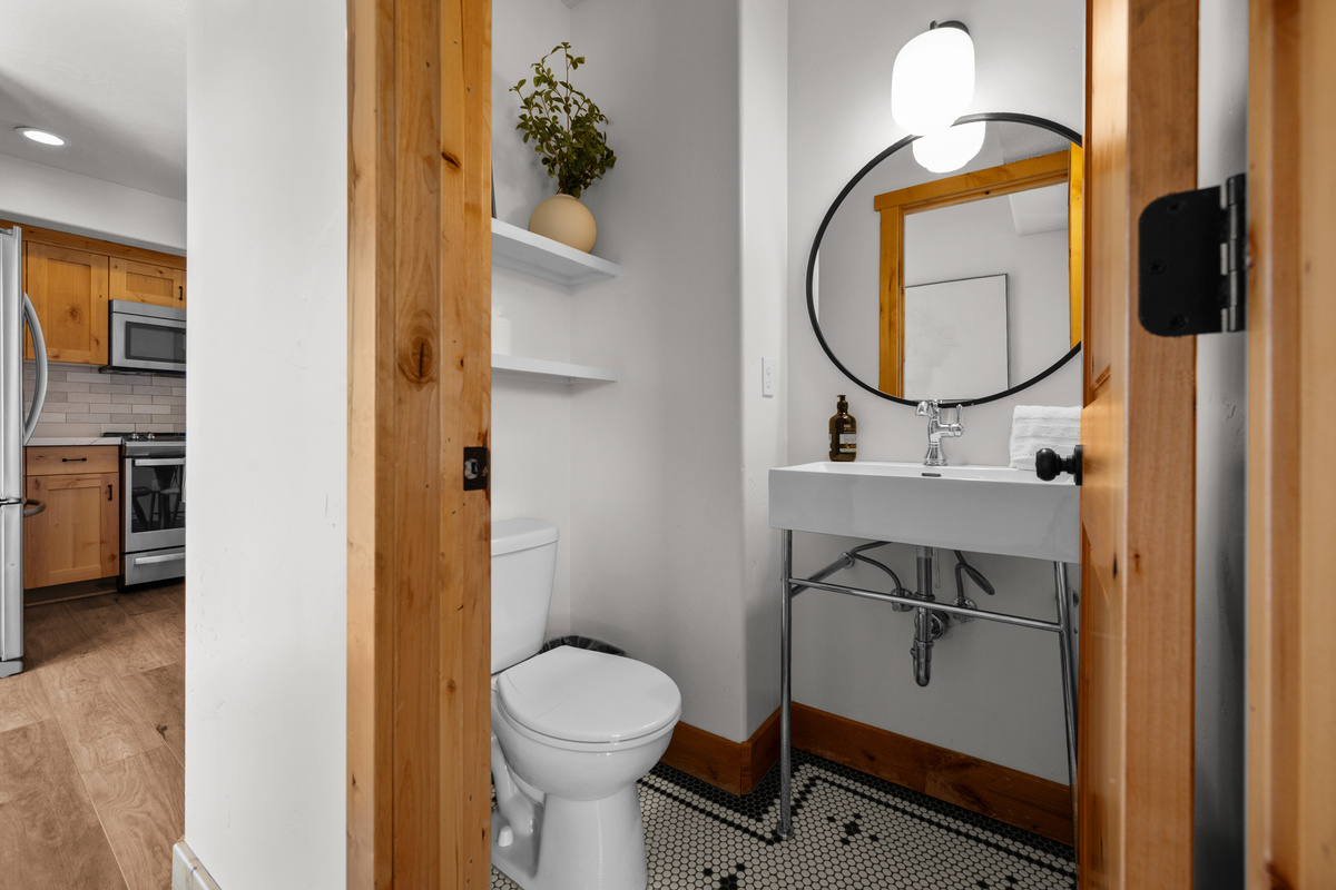 The conveniently located half bath off the kitchen adds extra functionality for groups.