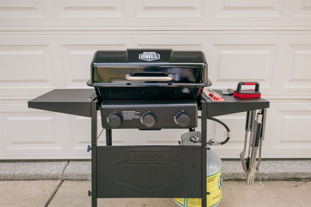 New propane grill with tools and grill cleaner. 