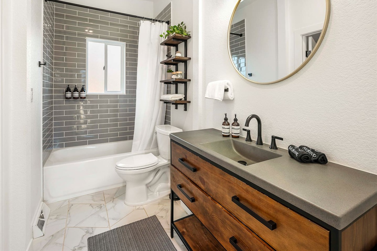 Full bath with modern design subway tile and soaking tub, stocked with essentials.