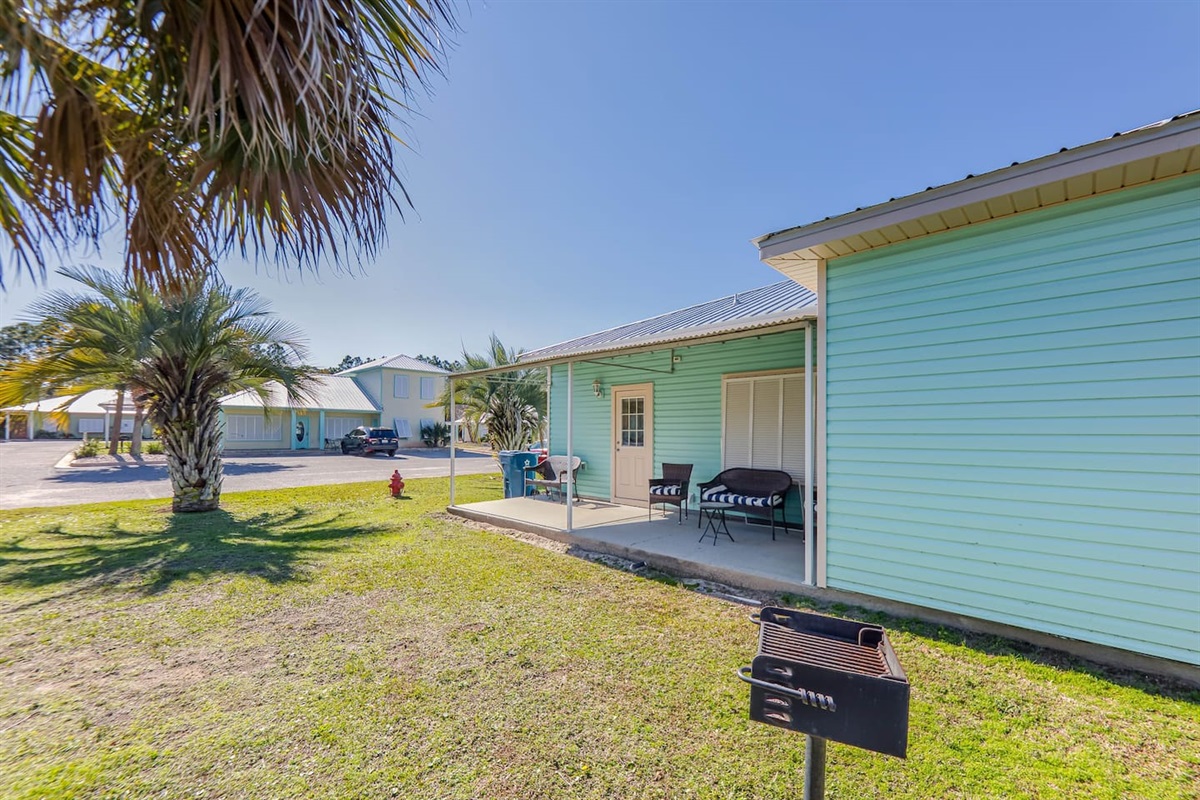 Charming Patio Escape: Relax outdoors under the sun with seating and BBQ grill!