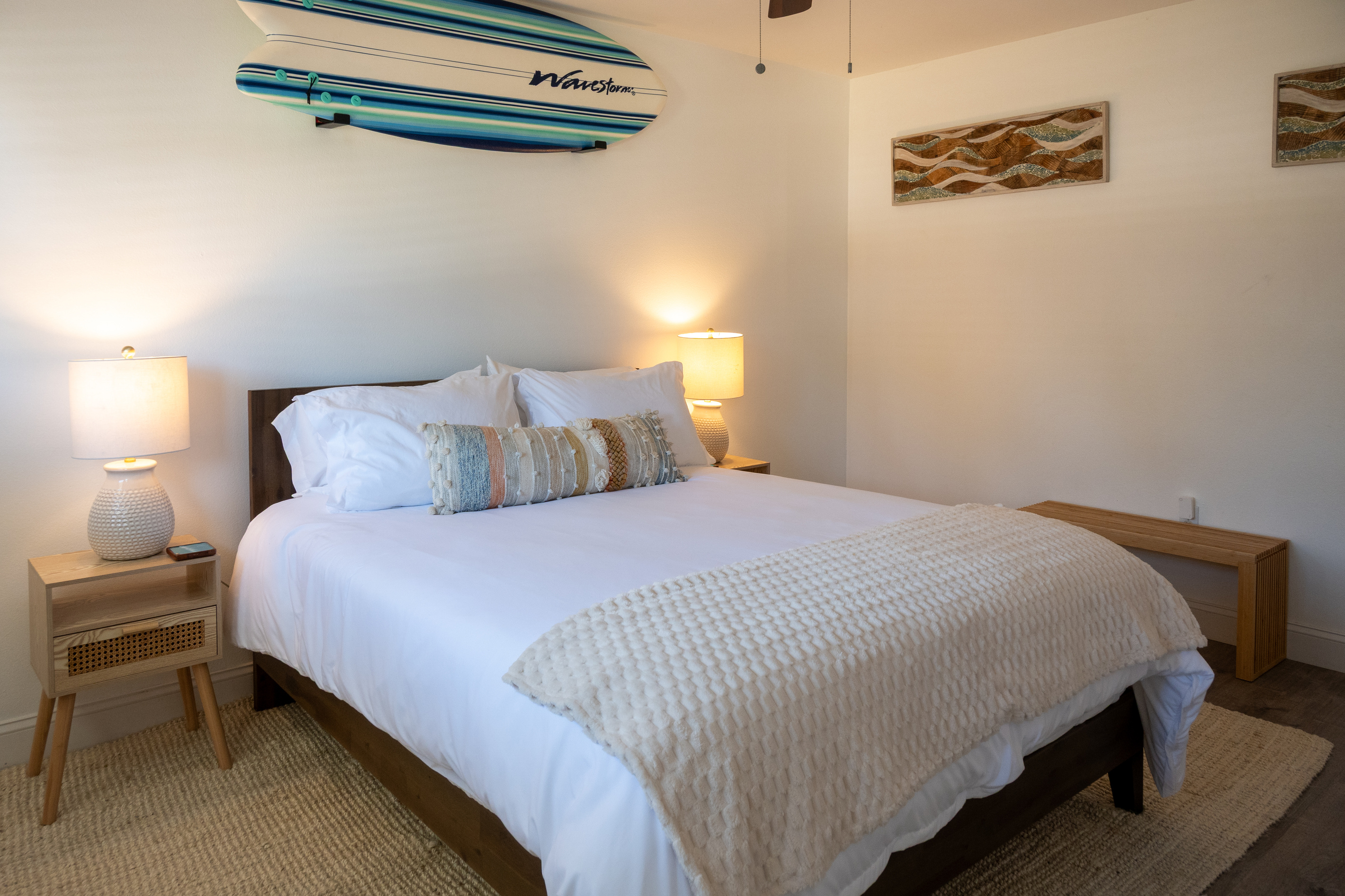 Bedroom 2: queen bed under the surfboard – boho coastal all the way