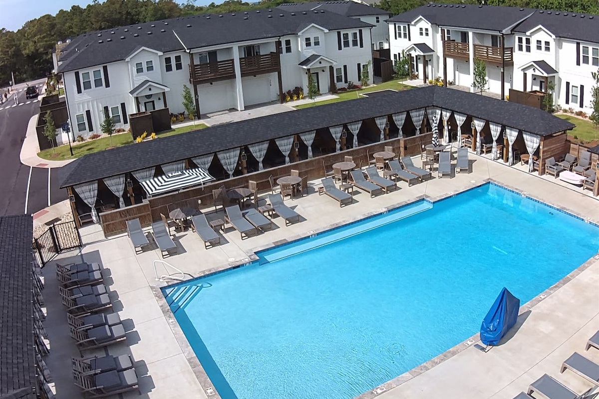 An overhead look at the pool area. It’s a well-maintained space with plenty of communal lounge chairs and rental cabanas nearby.
