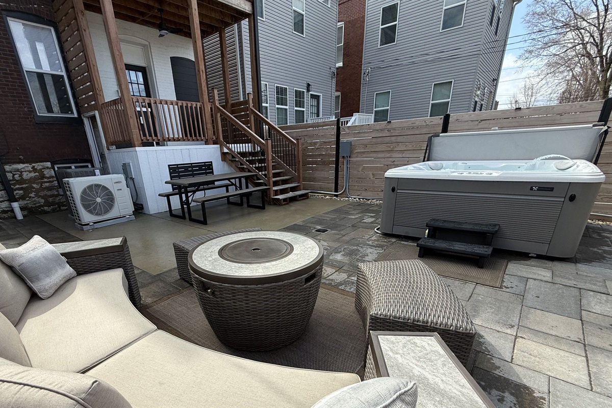 Enjoy a private backyard retreat featuring a 6-seater hot tub, gas grill, picnic table and plenty of lounge seating with a center fire table.