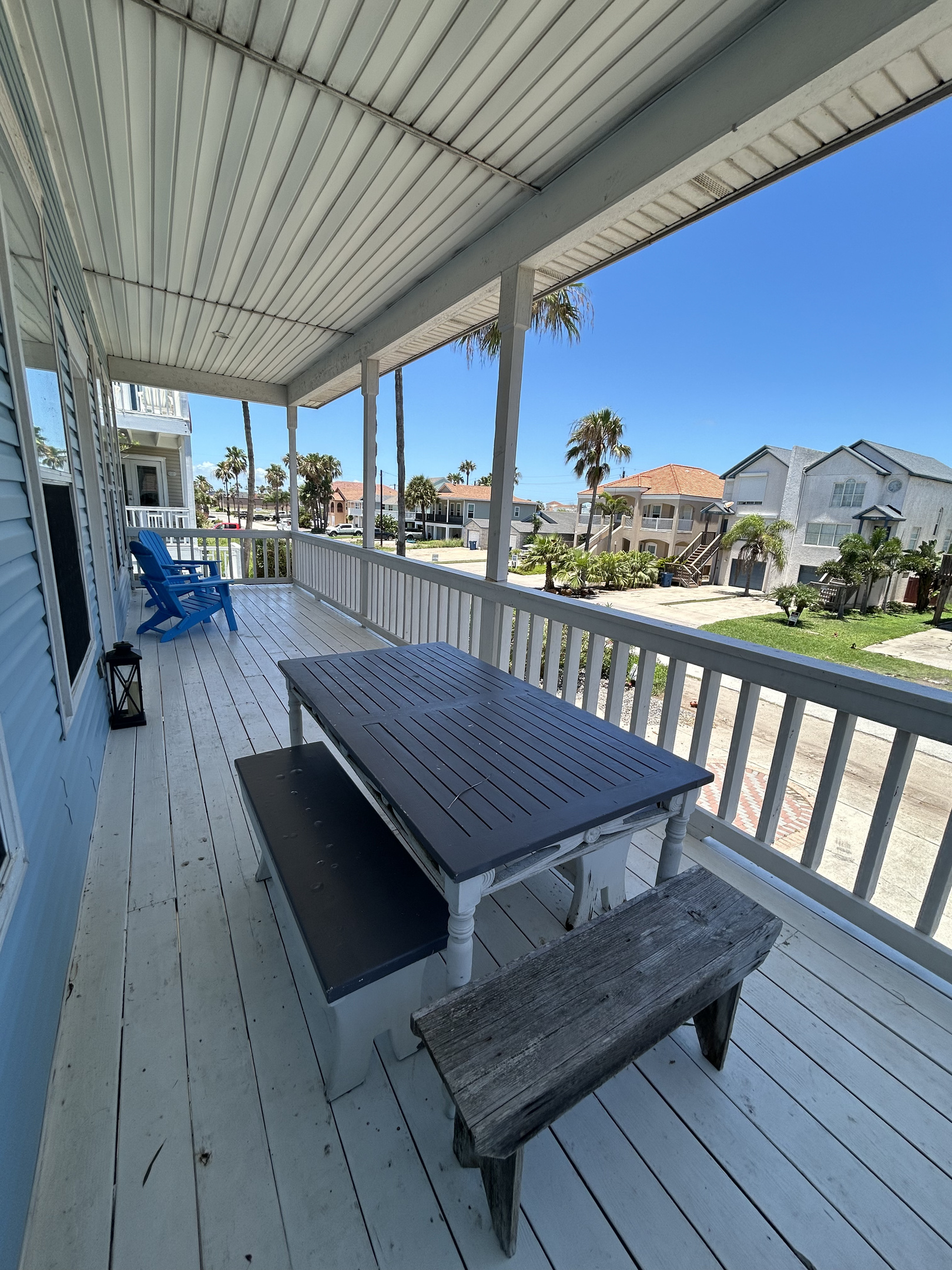 The second-floor main living balcony extends directly from the kitchen and living area, offering the perfect spot to enjoy morning coffee, evening cocktails, and refreshing coastal breezes.