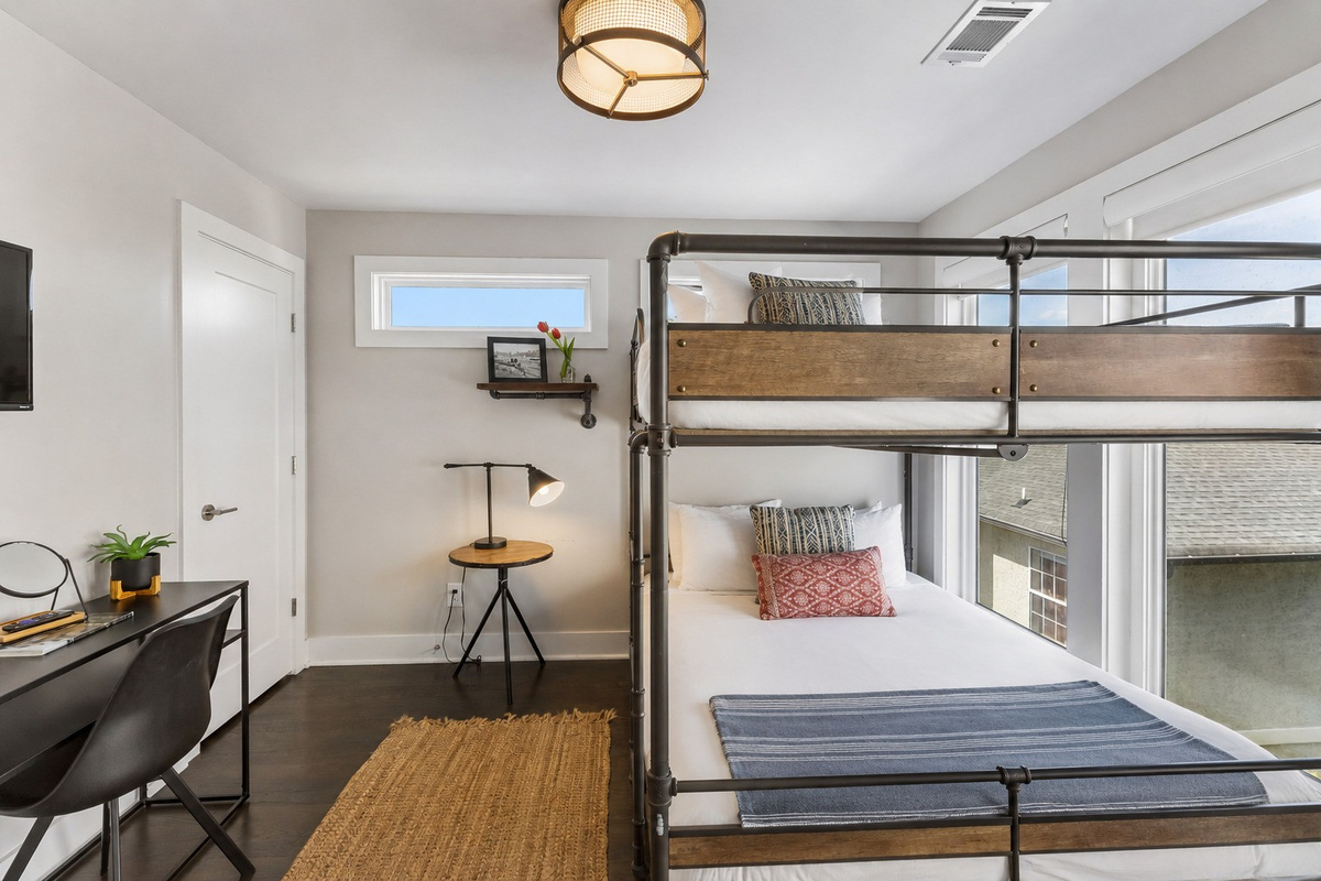 Let the kids call the bunk room before the adults finish unloading &mdash; queen over queen, industrial-style frame, and enough space for four to sleep comfortably.