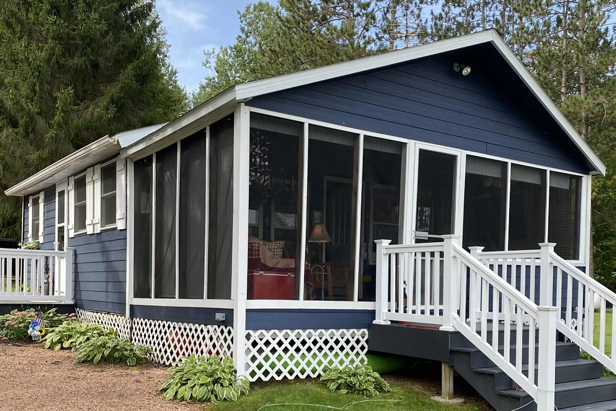 Screened in proch overlooking the water.