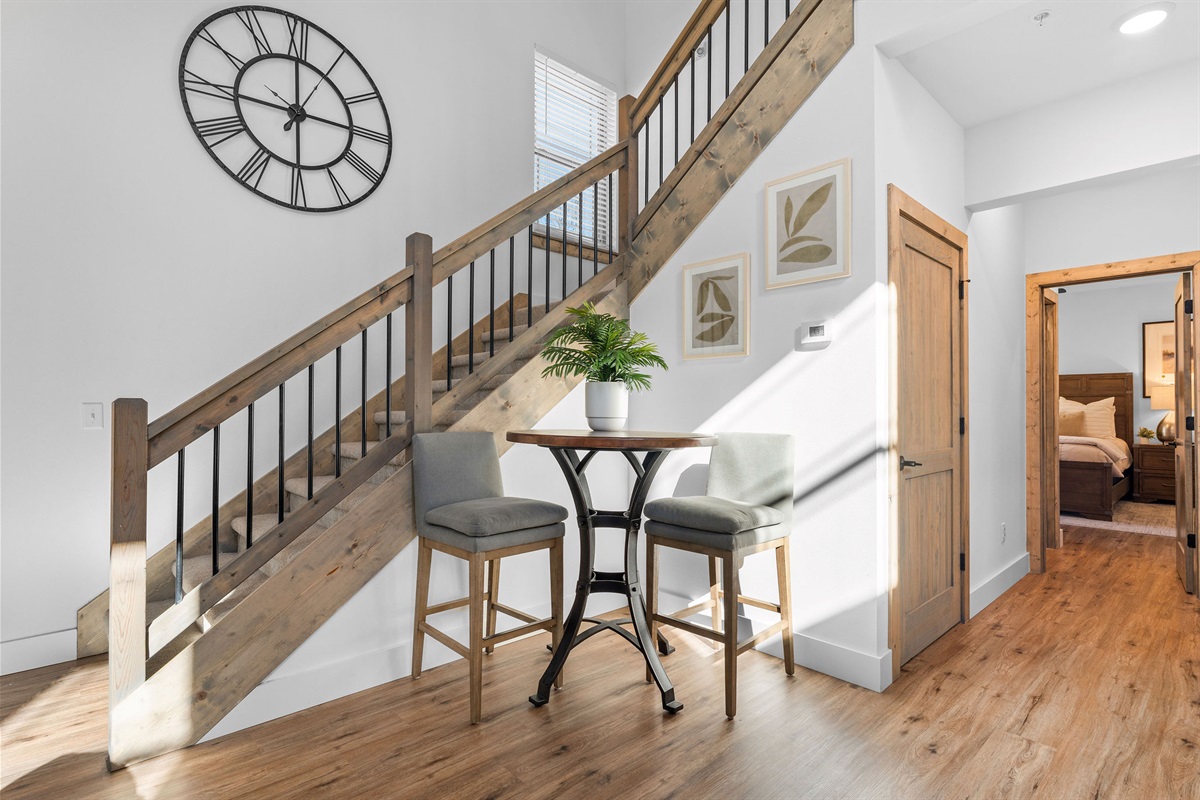 As we head back inside, you can see a small café-style table—a great spot for morning coffee. Or head up the stairs to the other two bedrooms with king beds and ensuite bathrooms.