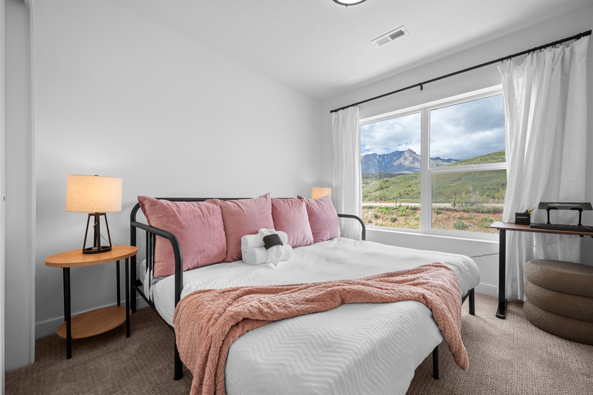 Serene upstairs bedroom with soft tones and natural light.