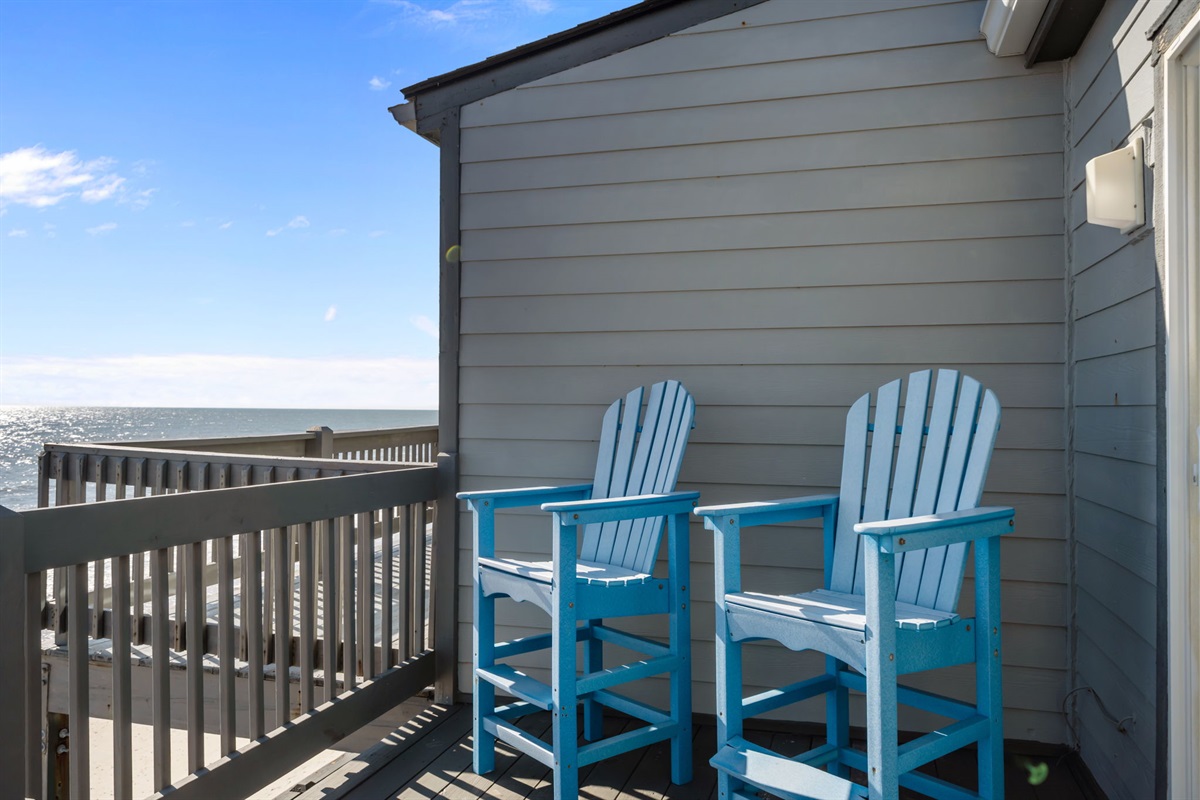 A quiet corner overlooking the shoreline, set up with seating to enjoy the rhythm of the waves