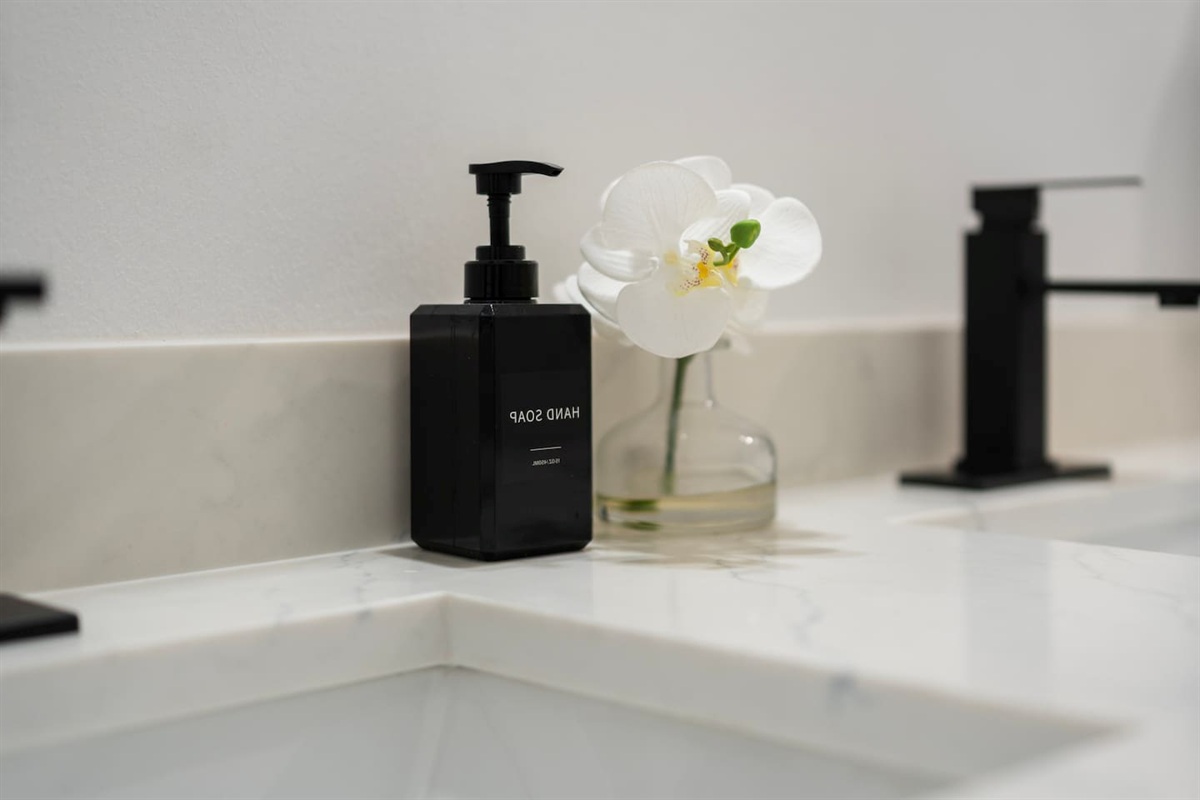 Premium Ginger Lily Farms shampoo, conditioner, and body wash provided for every stay — hotel-level amenities for added comfort.