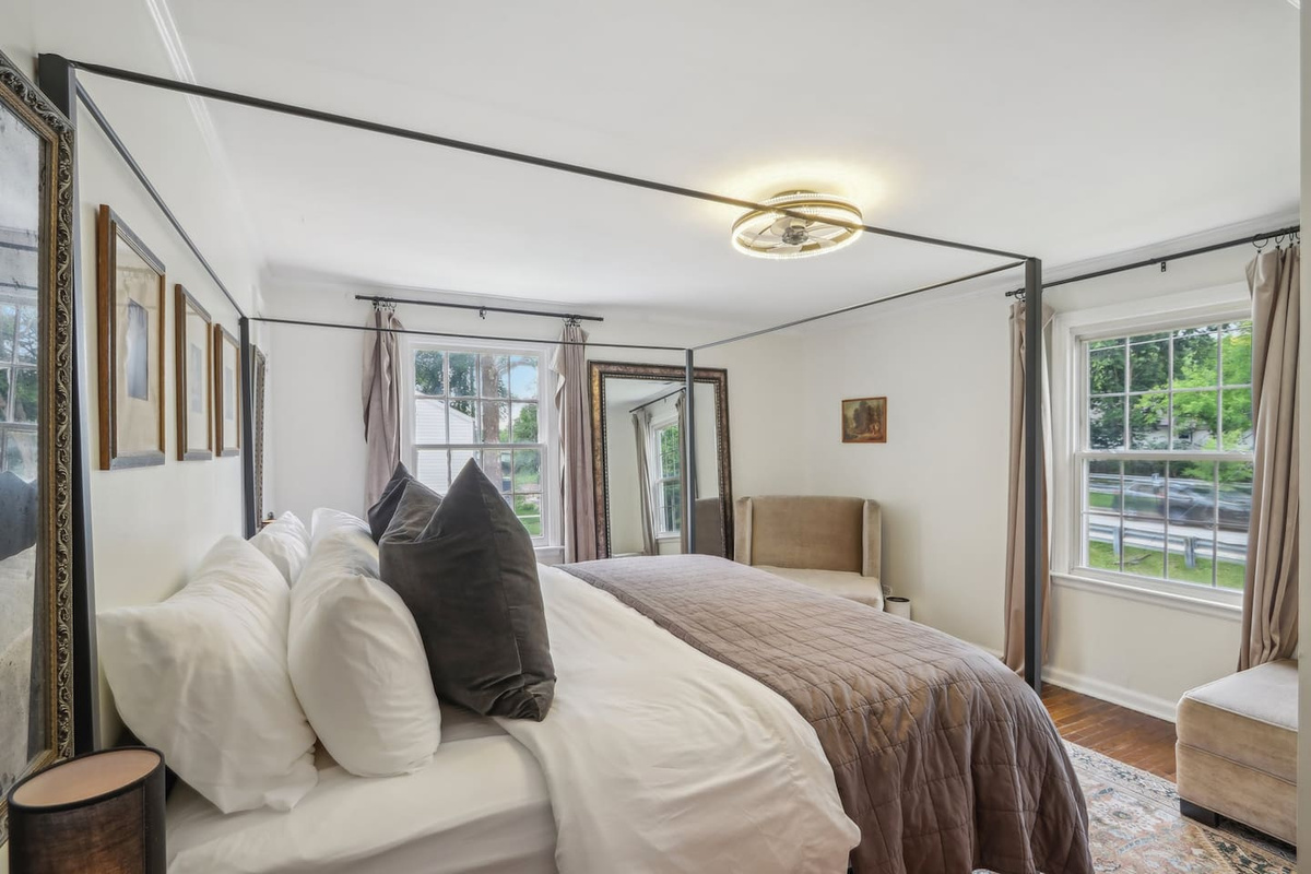 Unwind in the primary suite with a luxurious king-size bed, soft sheets, and cozy bedding designed for a restful stay.