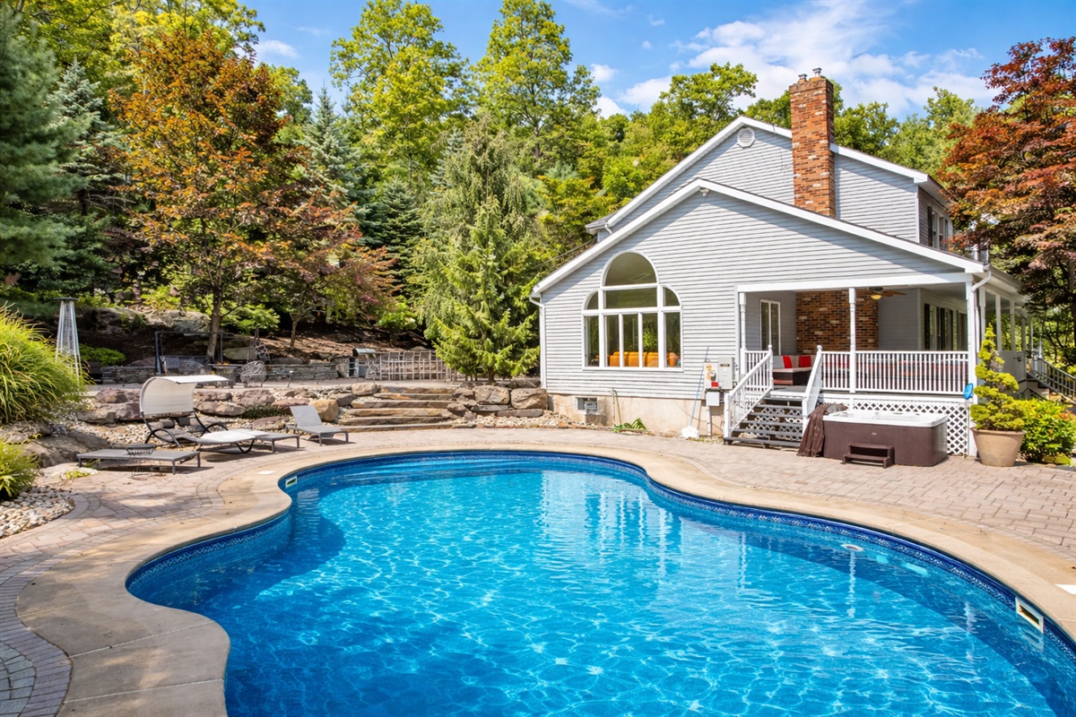 Spend sunny days by the private 20x40 pool, with loungers waiting on the stone patio
