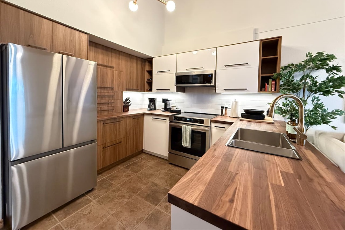 Full-Size French Door Fridge: Keep groceries fresh in the spacious, full-size french door refrigerator, a key amenity in this well-appointed vacation rental kitchen.