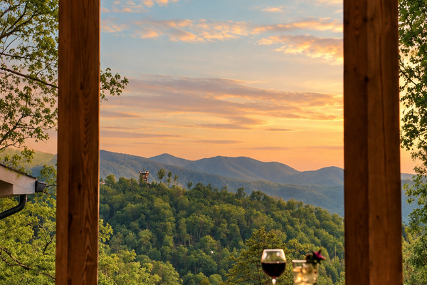 Watch the sky turn gold over rolling mountain ridges from the railing.