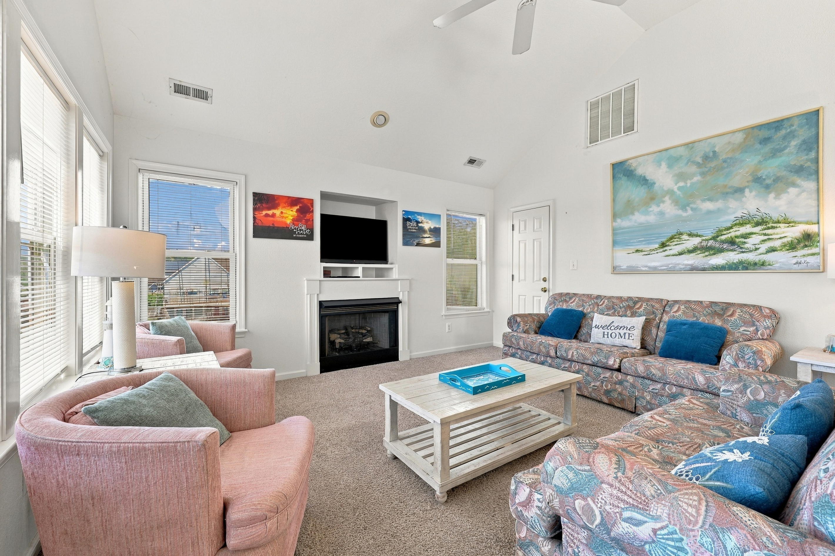 The living room gathers around the fireplace and TV, perfect for movie night.