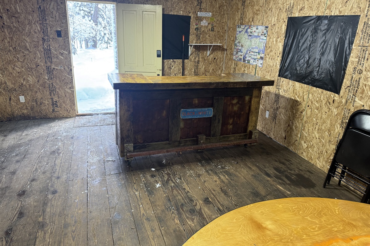 Heated seasonal garage lounge with TV, poker table, and gathering space for your group.