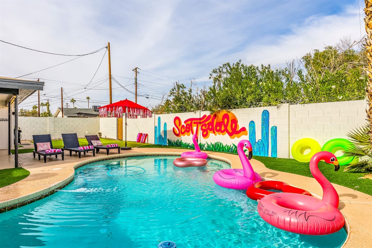 Snap Insta-worthy shots with flamingo floats in front of our bold Scottsdale mural—your perfect desert escape awaits!

