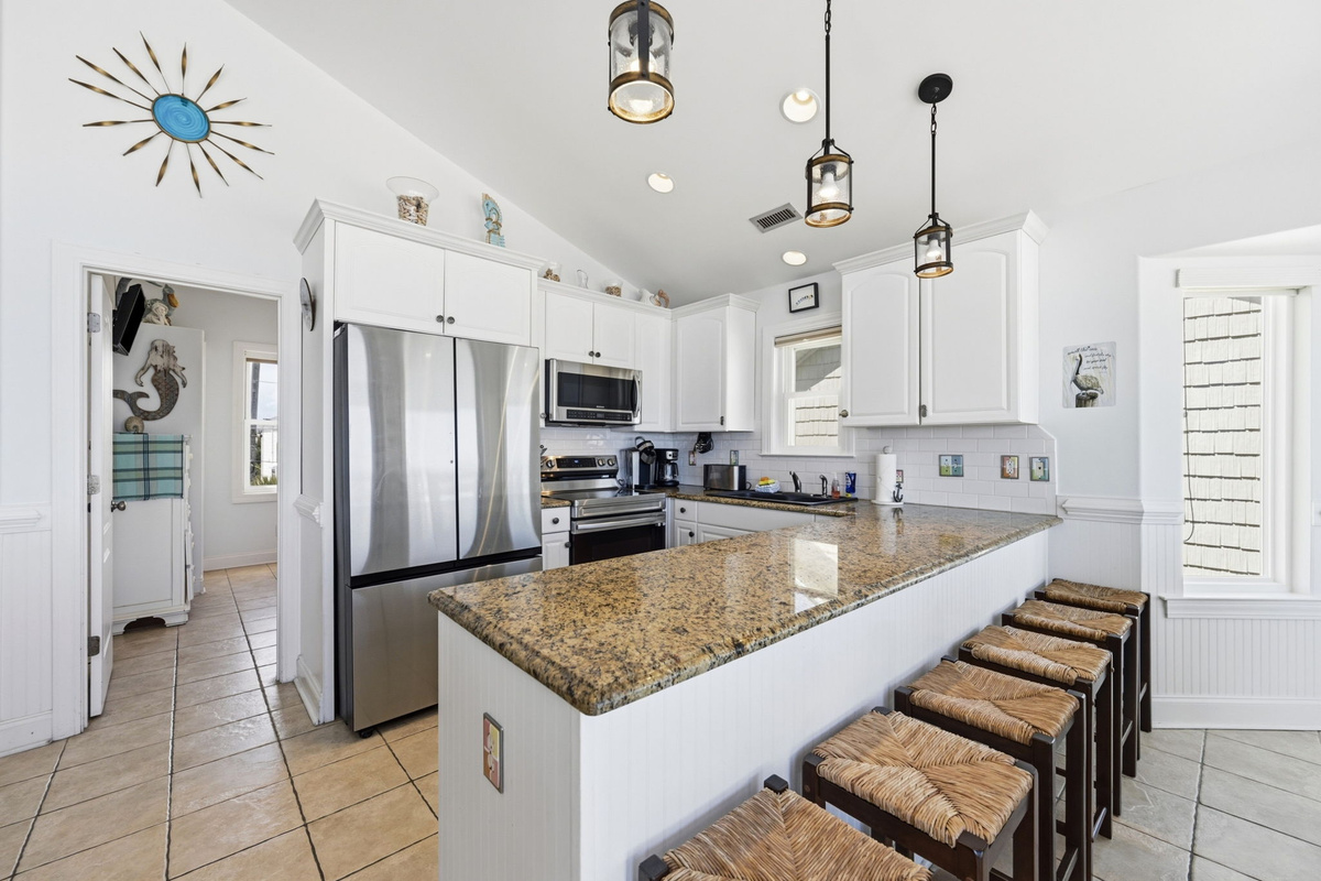 Clean coastal kitchen with everything you need, nothing you don&rsquo;t, and views that keep you cooking