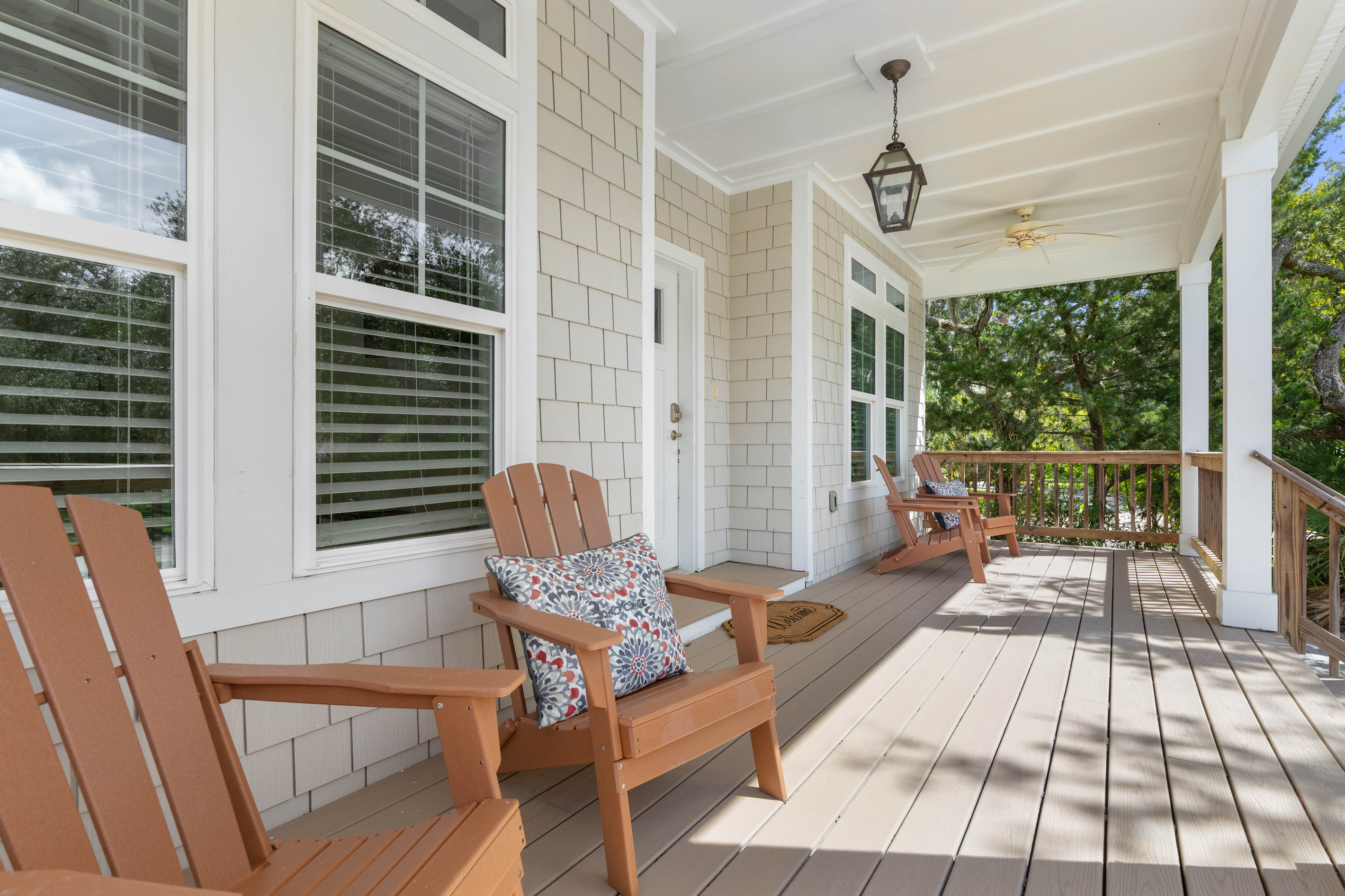 Cedar Adirondacks angled out toward the street, a lantern overhead for when the light goes, and deck enough to leave sandy flip-flops by the door. The early risers claim this spot with their coffee first.