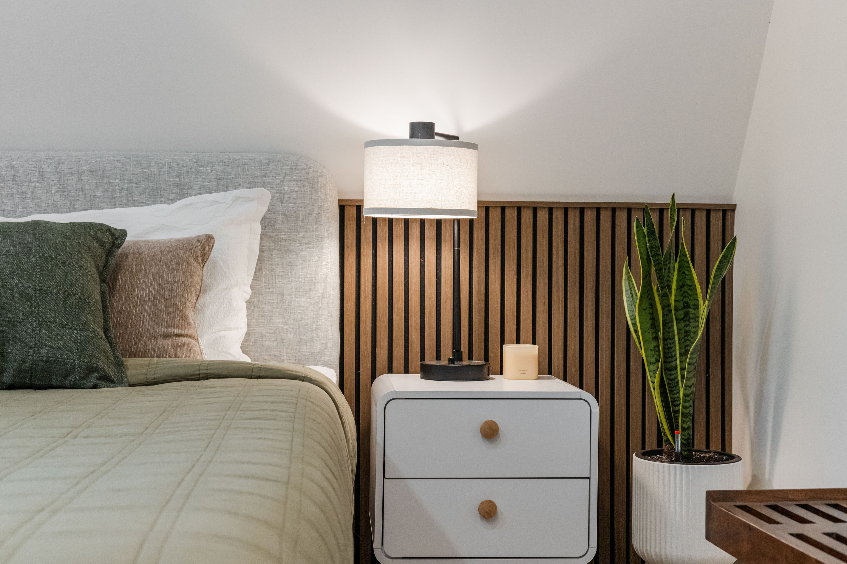 Green linen, oak slats, lamp on low