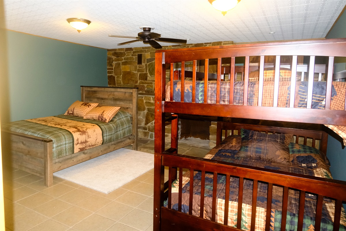Comfy room for a good slumber party. Queen standalone bed. Double over Double bunks + a single trundle