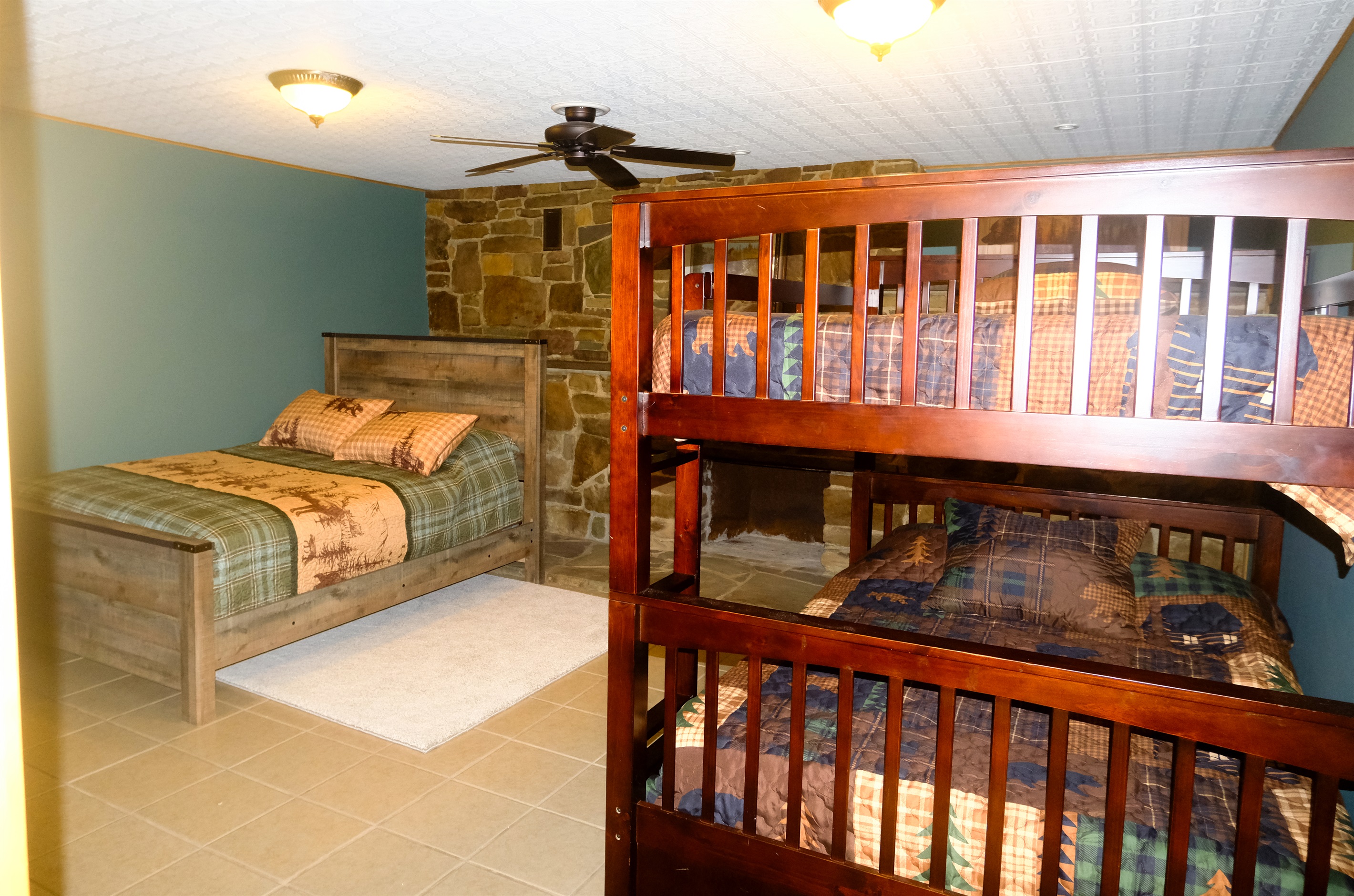 Comfy room for a good slumber party. Queen standalone bed. Double over Double bunks + a single trundle