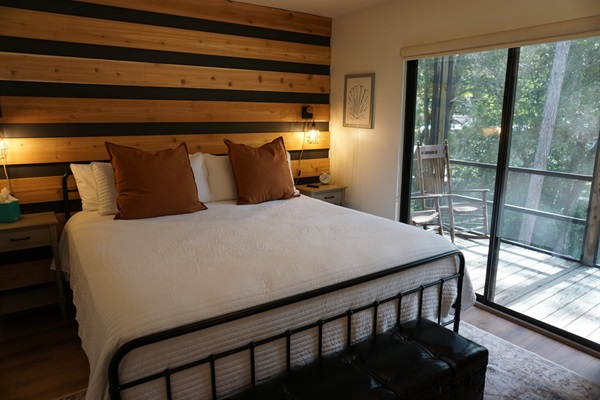 Downstairs bedroom is fitted with a king size bed, Roku TV & sliding doors to the balcony.