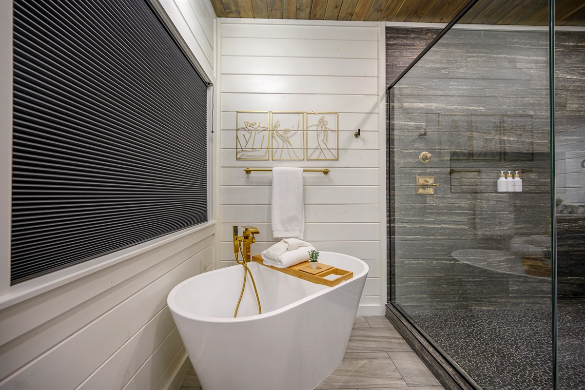 A well-designed bath space featuring a tub with tray setup, ideal for soaking and taking your time to relax