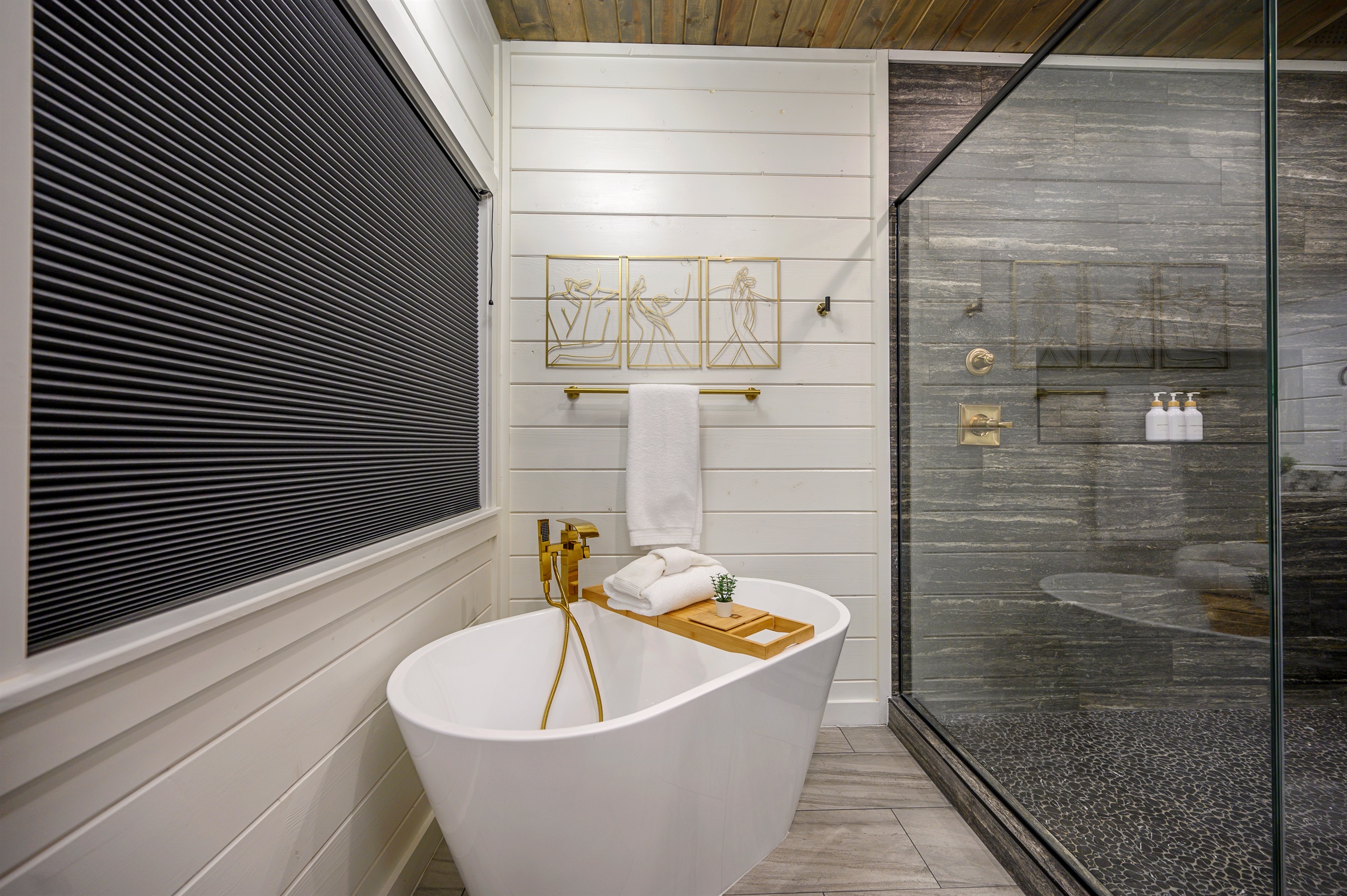 A well-designed bath space featuring a tub with tray setup, ideal for soaking and taking your time to relax