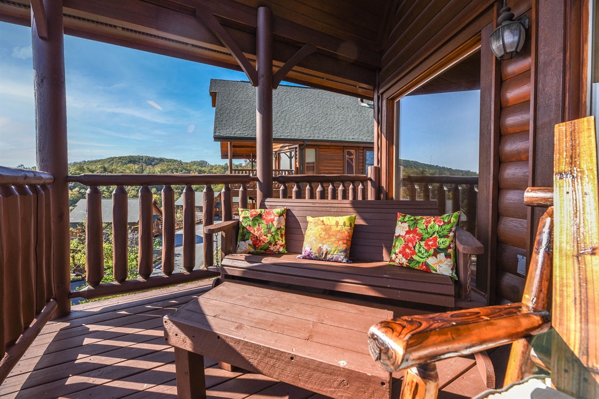 - Cozy outdoor nook with cushioned seating and serene Smoky Mountain views   - Perfect for reading, chatting, or sipping wine in fresh mountain air   - A peaceful corner designed for comfort and quiet moments outdoors