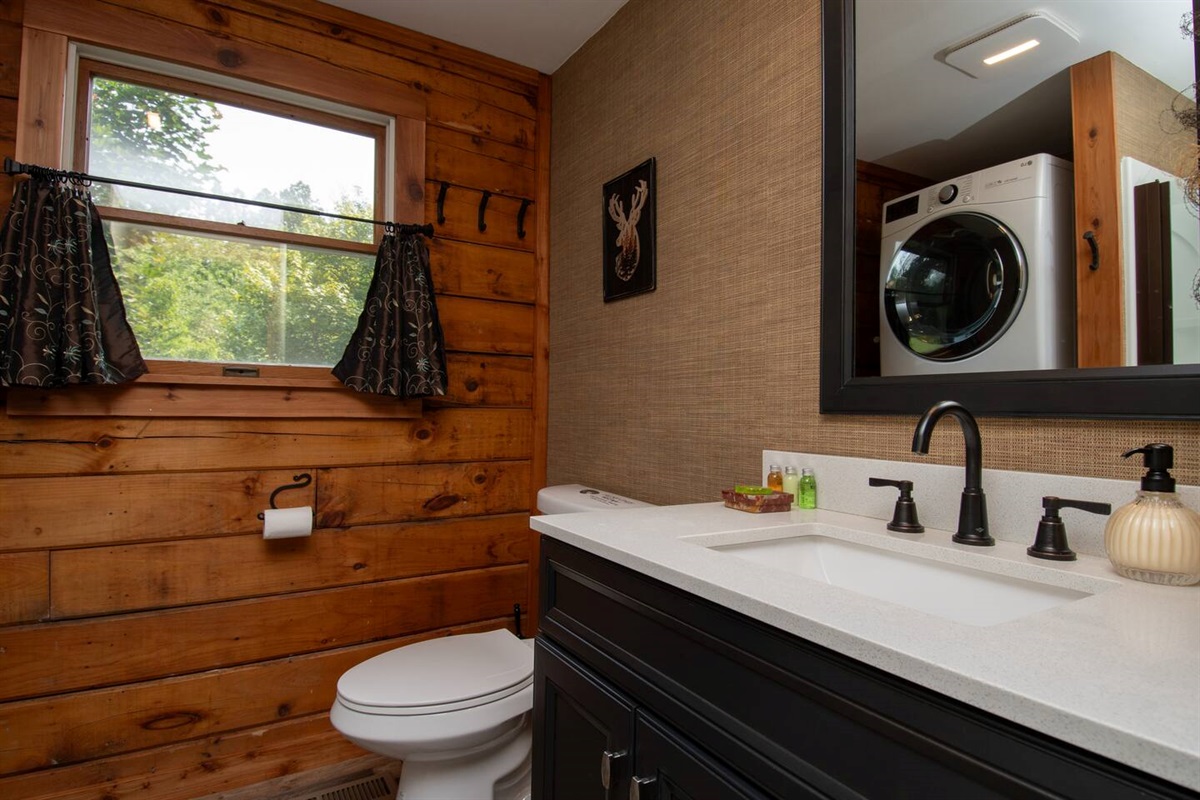 First floor bathroom with shower and laundry. There is enough hand soap for your stay along with 1 ounce starter bottles of shampoo, conditioner and shower gel. You will also be provided with enough toilet paper for your stay.